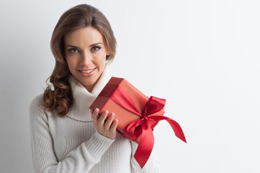 Smiling cute girl with red christmas gift box