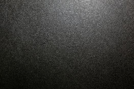 Dark full frame background of hammered powder paint coating on flat sheet steel surface. Also known as hammertone effect.