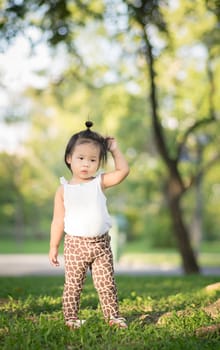 Portrait of little girl  walking in the park