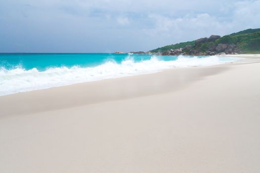 The beach with white sand and turquoise water with waves