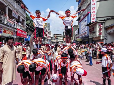 Pune,Maharashtra,India-September 22nd,2010: Acrobats doing gymnastic acts during Ganesh festival procession.