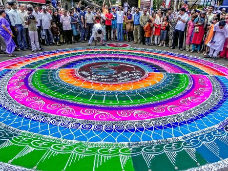 Pune,Maharashtra,India-September 22nd,2010: Artists drawing huge, traditional, colorful rangoli before arrival of Lord ganesh.