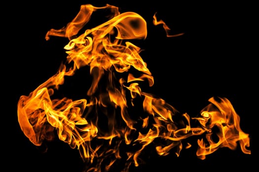 Fire flames on black background isolated. Burning gas or gasoline burns with fire and flames. Flaming burning sparks close-up, fire patterns. Infernal glow of fire in the dark with copy-space