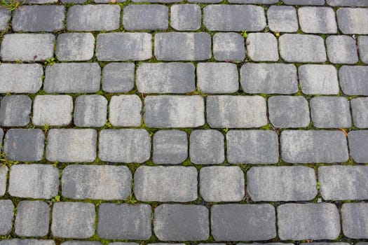 Texture of concrete pavement or sidewalk with paving slabs, top view. Blocks of the sidewalk pattern, details of the stone-tiled path.