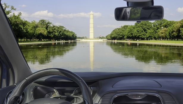 Looking through a car windshield with view of the Washington Monument and Reflecting Pool, Washington DC, USA