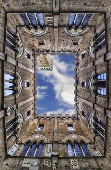 Scenic view from the bottom at the patio of Palazzo Pubblico, major landmark in Siena, Italy