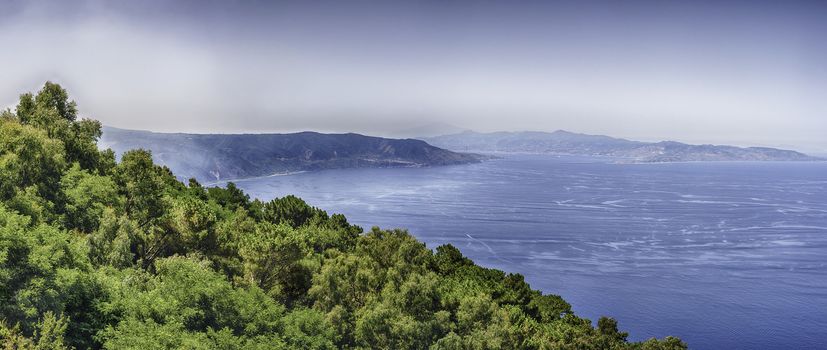 Panoramic aerial view of the Strait of Messina, between the eastern tip of Sicily and the western tip of Calabria in the south of Italy, as seen from the top of Mount Sant'Elia, Palmi, Italy