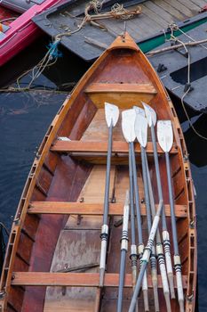 Oars in a wooden rowing boat for hire, moored on the River Thames, London, England