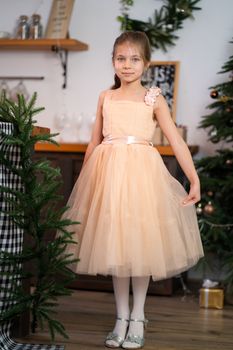 Little girl in princess dress celebrates christmas. Christmas magic fairy tale. Happy childhood.