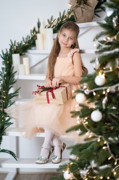 Little girl in princess dress celebrates christmas. Christmas magic fairy tale. Happy childhood.