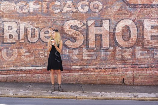 A gorgeous blonde model enjoys a summers day outdoors in a small town