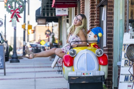 A gorgeous blonde model enjoys a summers day outdoors in a small town