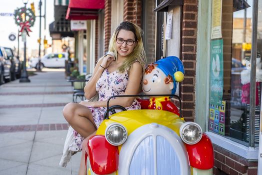 A gorgeous blonde model enjoys a summers day outdoors in a small town