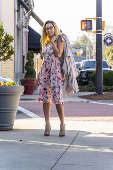 A gorgeous blonde model enjoys a summers day outdoors in a small town