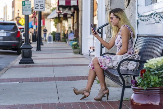 A gorgeous blonde model enjoys a summers day outdoors in a small town