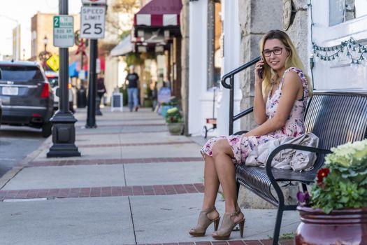 A gorgeous blonde model enjoys a summers day outdoors in a small town