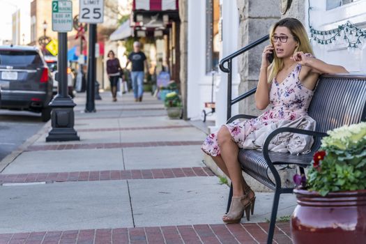 A gorgeous blonde model enjoys a summers day outdoors in a small town