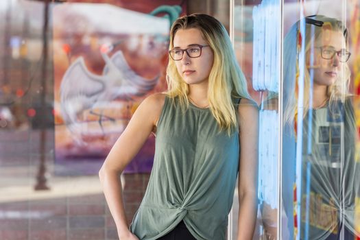 A gorgeous blonde model enjoys a summers day outdoors in a small town