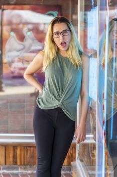 A gorgeous blonde model enjoys a summers day outdoors in a small town