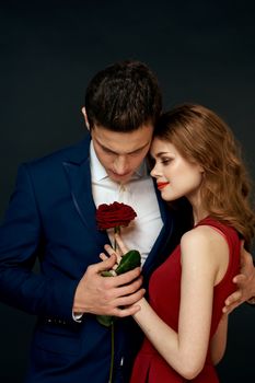 Beautiful couple charm hug lifestyle relationship rose luxury dark background. High quality photo