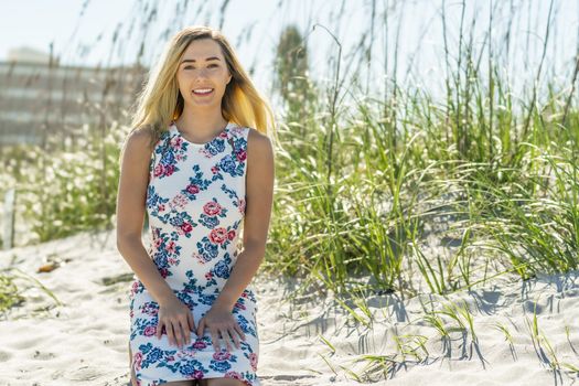 A gorgeous young blonde female enjoys a day at the beach alone