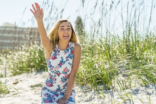 A gorgeous young blonde female enjoys a day at the beach alone