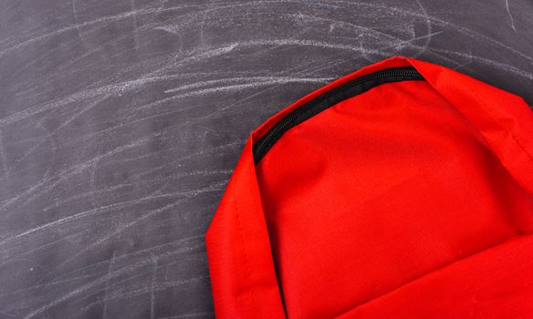Back to school shopping pocket backpack on the education red bag on blackboard and chalkboard
