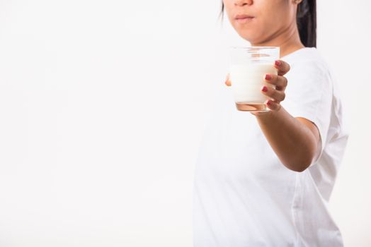 Asian portrait of happy young Asian beauty woman use hands hold drink white milk from a glass, studio shot isolated on white background, Food healthy care concept