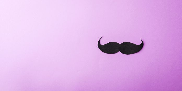 Black mustache paper, studio shot isolated on purple background, Prostate cancer awareness month, Fathers day, minimal November moustache concept