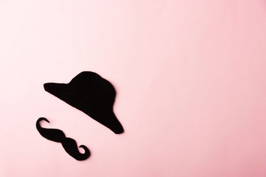 Black mustache and cap, studio shot isolated on pink background, Prostate cancer awareness month, Fathers day, minimal November moustache concept