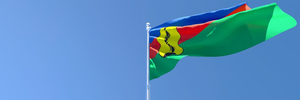 3D rendering of the national flag of New Caledonia waving in the wind against a blue sky