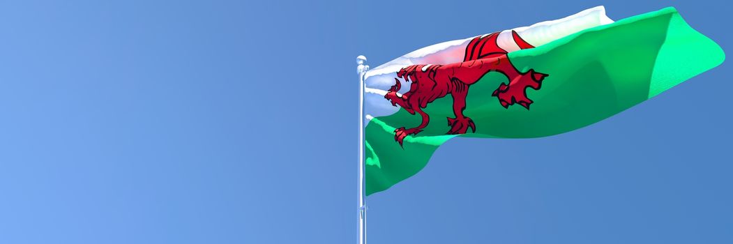 3D rendering of the national flag of Wales waving in the wind against a blue sky