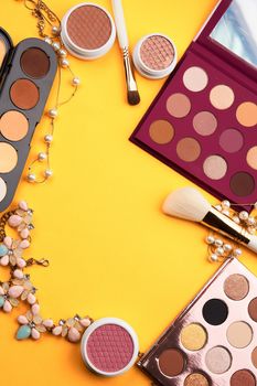 eyeshadow professional cosmetics blush powder yellow background top view. High quality photo