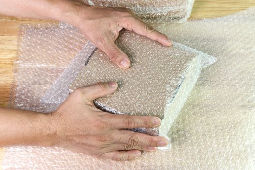 hand of man hold bubble wrap, for protection parcel product cracked or insurance During transit  