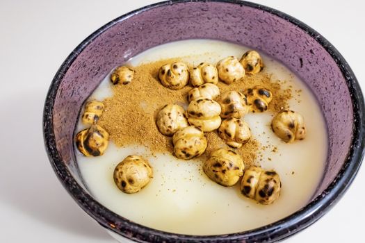 traditional turkish drink boza in glass with cinnamon powder and roasted chickpeas