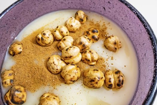 traditional turkish drink boza in glass with cinnamon powder and roasted chickpeas