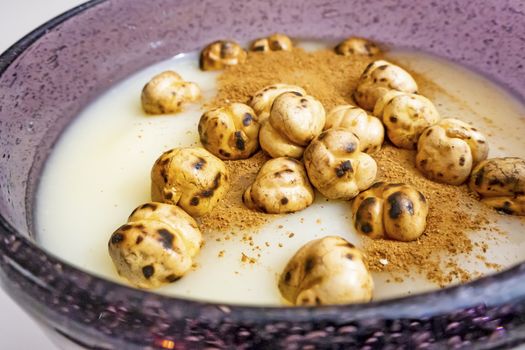 traditional turkish drink boza in glass with cinnamon powder and roasted chickpeas