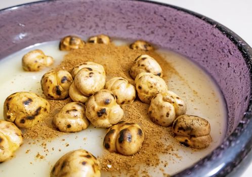 traditional turkish drink boza in glass with cinnamon powder and roasted chickpeas