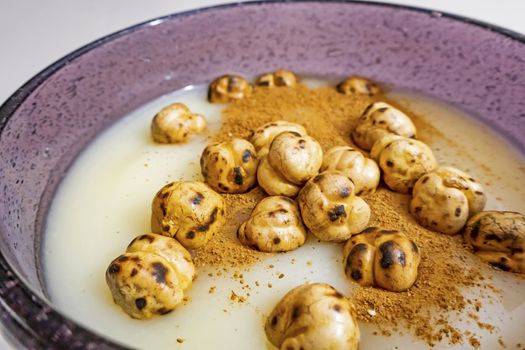 traditional turkish drink boza in glass with cinnamon powder and roasted chickpeas