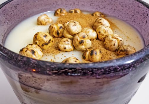 traditional turkish drink boza in glass with cinnamon powder and roasted chickpeas