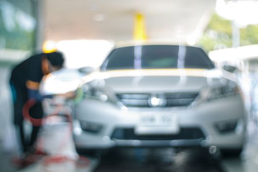 abstract blur and defocused waxing and polishing at car care center for background