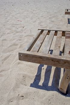 wooden sun lounger chair for sunbathing on the beach