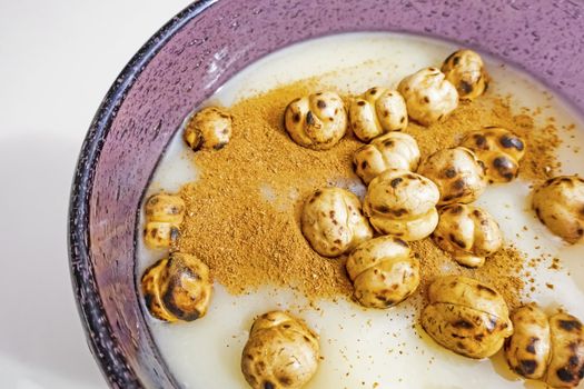 traditional turkish drink boza in glass with cinnamon powder and roasted chickpeas