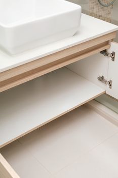 detail of cupboard or wardrobe under sink in bathroom, built-in furniture in modern condominium