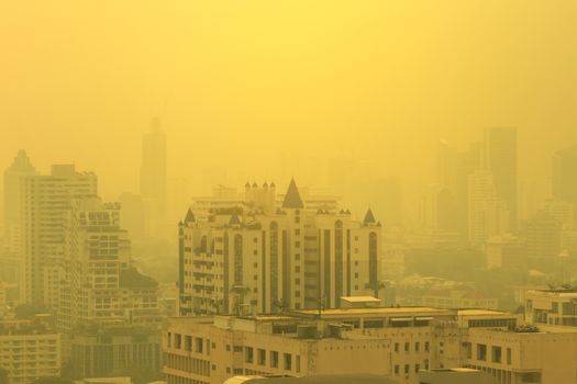 smog city in summer with morning sunlight, haze of pollution covers city, global warming concept