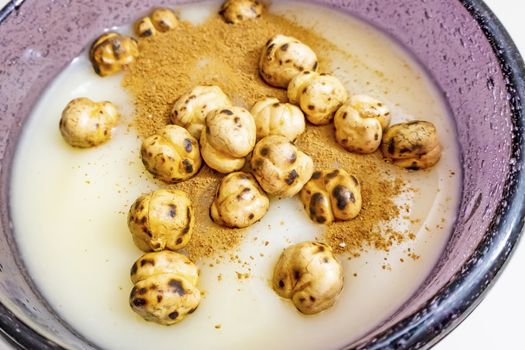 traditional turkish drink boza in glass with cinnamon powder and roasted chickpeas