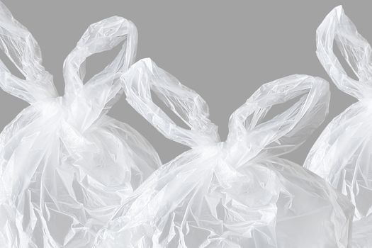single-use plastic bags on grey background, polyethylene plastic, green environment concept