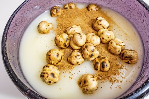 traditional turkish drink boza in glass with cinnamon powder and roasted chickpeas