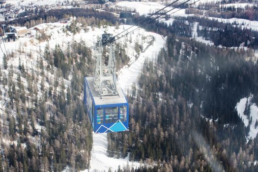Gondola lift cable car on ski resort Cortina d'Ampezzo winter city view from Toffana ski area