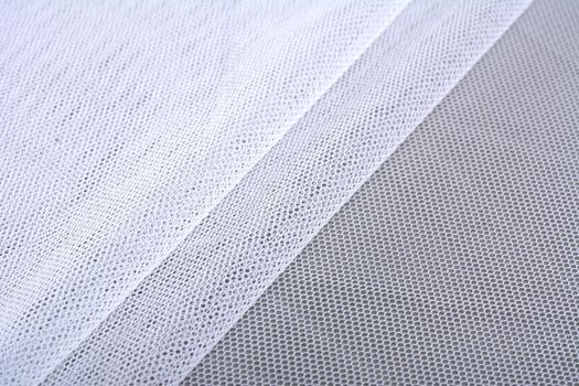 white Knitted elastic fabric, weaving of threads texture, crumpled fold. For underwear, sports clothes and swimwear. Space for text.